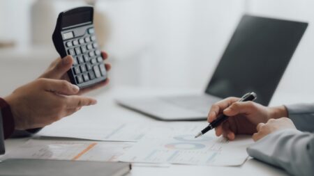 Businessmen calculating taxes