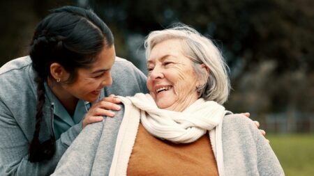 Caregiver with senior woman in park