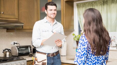 Contractor working with homeowner in kitchen