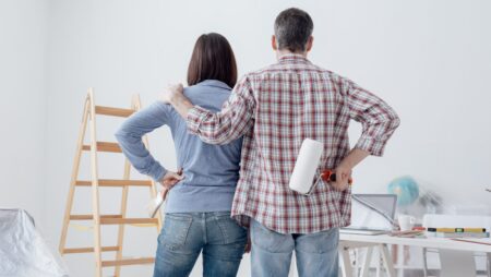 Couple painting interior home renovations