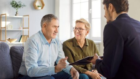 Couple with realtor discussing homeowners insurance