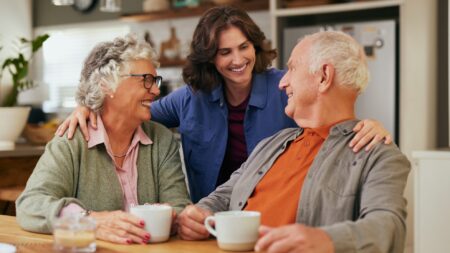 Daughter with aging parents drinking tea