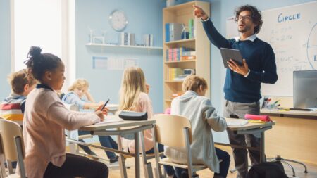 Elementary school teacher giving lesson