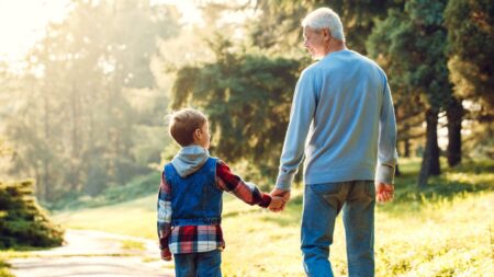 Grandfather and grandson walking outdoors
