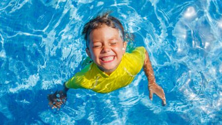 Happy child playing in the pool