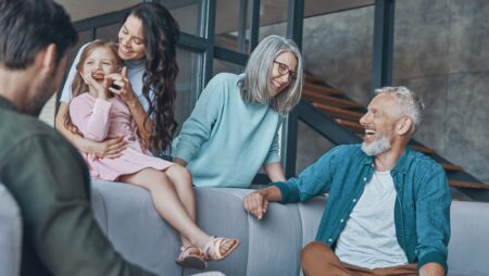 Happy family on sofa at home generational living