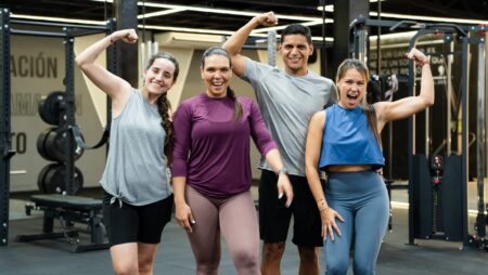 Happy group of fitness athletes in gym