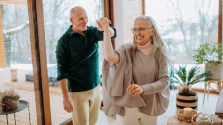 Happy senior couple dancing living room