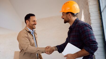 Home owner shaking hands with home remodeling contractor