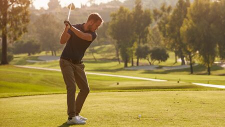 Man golfing hitting tee shot