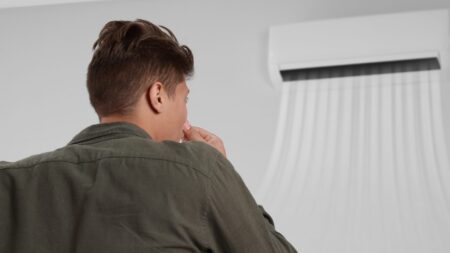 Man observing air conditioner bad smell