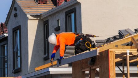 Man repairing roof residential home