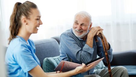 Man with care giver at senior home