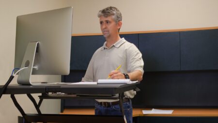 Man working at standup desk in office ergonomics