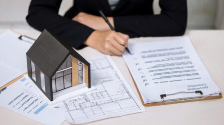 Real estate agent reviewing documents at desk