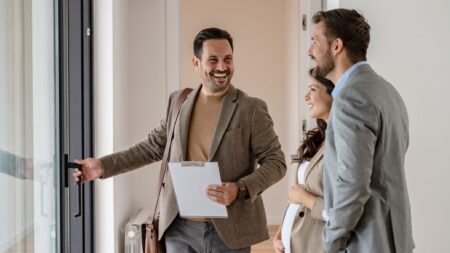 Real estate agent showing house to couple