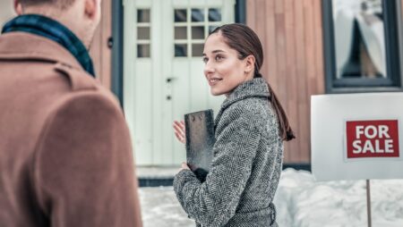 Real estate agent showing house winter
