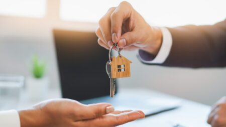 Realtor giving house keys to buyer