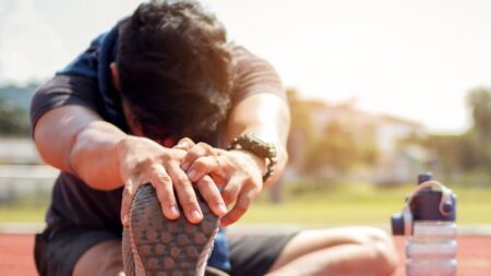Runner stretching on track