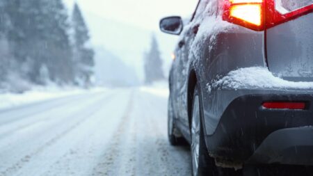 SUV driving on snowy road winter
