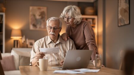 Senior couple at home reviewing documents