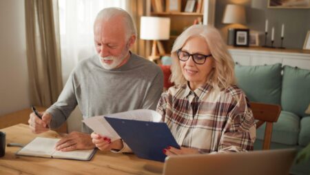 Senior couple at home reviewing financial documents