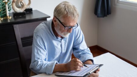 Senior man examining reverse mortgage application