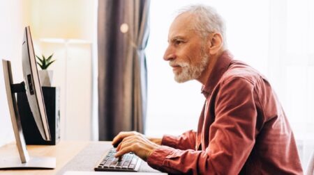 Senior man surfing the web desktop computer