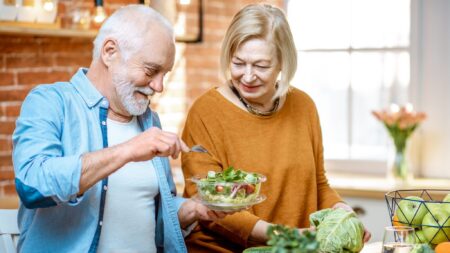 Senior couple with salad seasonal eating well-being