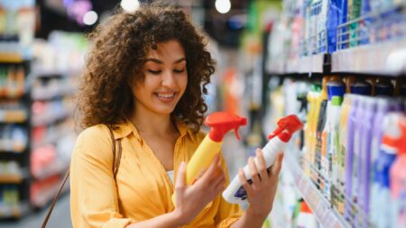 Woman choosing cleaning products at store