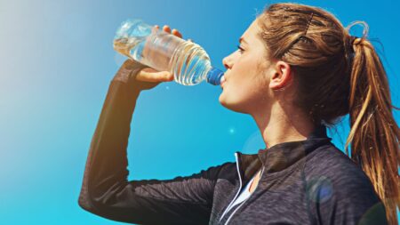 Woman drinking water on outdoor run