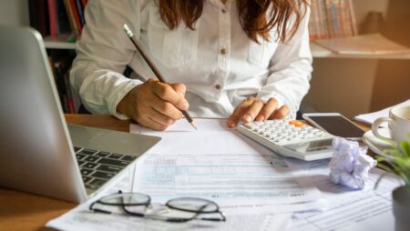 Woman filling out tax form at desk
