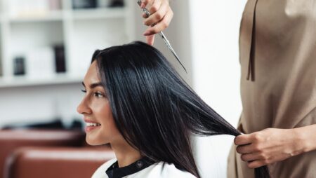 Woman getting haircut at salon