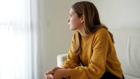 Woman looking out window burnout depression