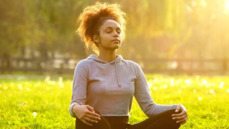 Woman meditating in grass