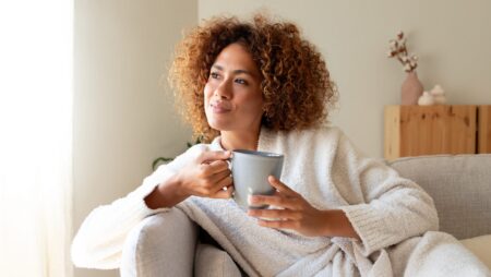 Woman relaxing at home drinking tea