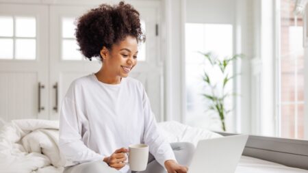 Woman relaxing in bed with coffee wellness