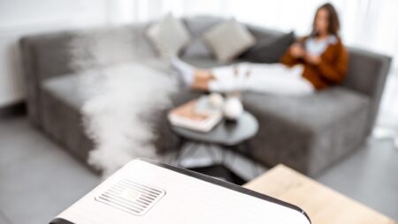 Woman relaxing on couch with humidifier dry winter air