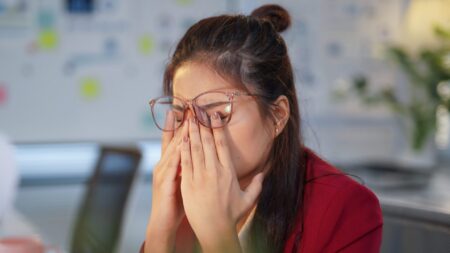 Woman rubbing eyes dry eye syndrome