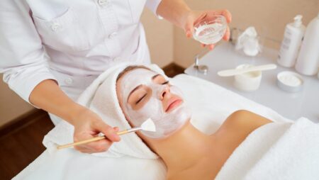 Woman with face mask facial treatment spa beauty salon