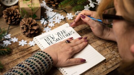 Woman writing new year resolutions