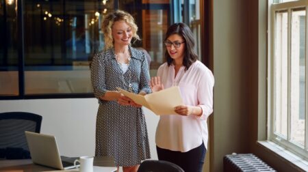 Women reviewing document in real estate office