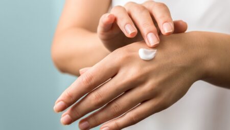 healthy hands and nails. seasonal skin protection. woman applying moisturizer on her hands
