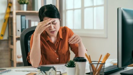 stressed architect having headache while working