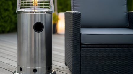Modern outdoor patio heater and dark wicker furniture create an inviting space perfect for relaxation and cozy evenings with friends and family