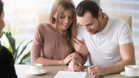 Couple signing prenuptial agreement