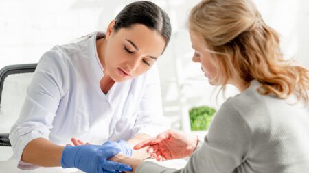 Dermatologist examining patient