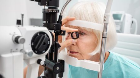 Eye exam senior woman retina