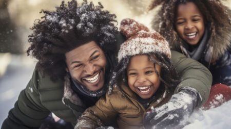 Father and children playing in snow