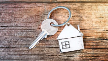 House key and keychain on wood table